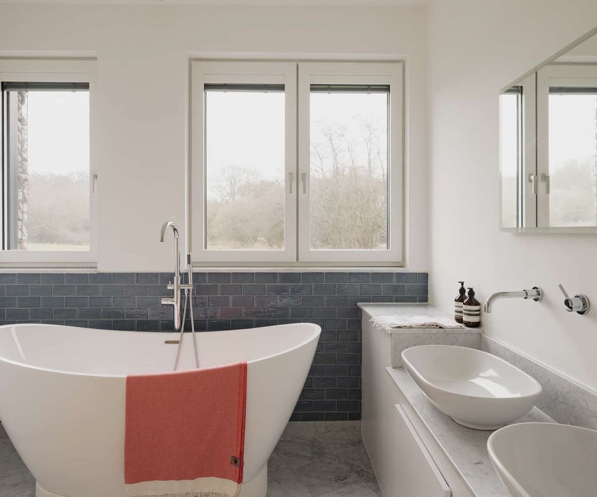 A white bath and his and her sinks