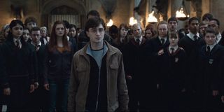 Harry Potter stands in front of his fellow Hogwarts students in the Great Hall in 'Harry Potter and