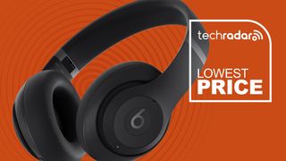 Beats Studio Pro against an orange background with some writing on it