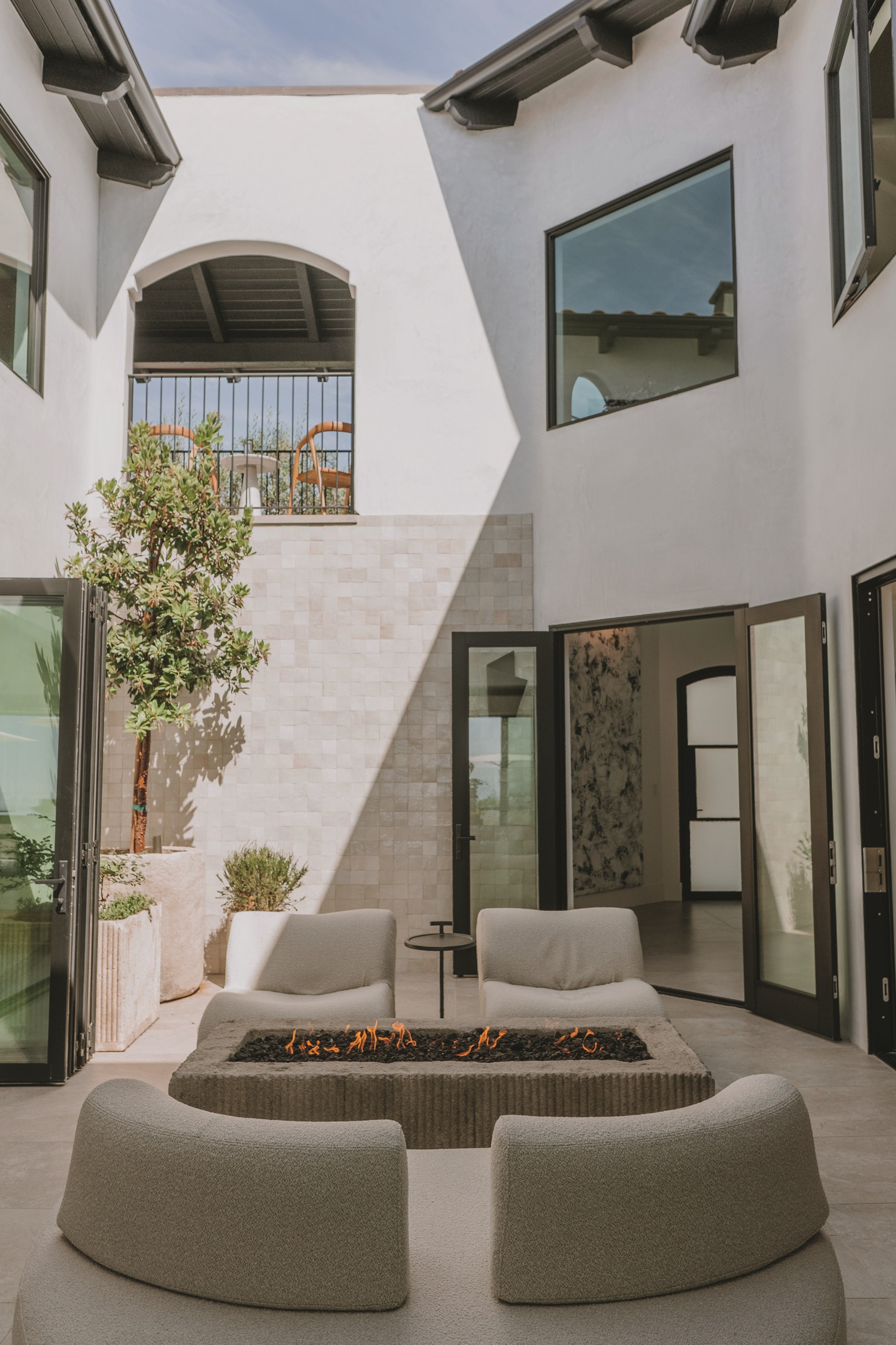 a minimalist outdoor firepit in a contemporary courtyard