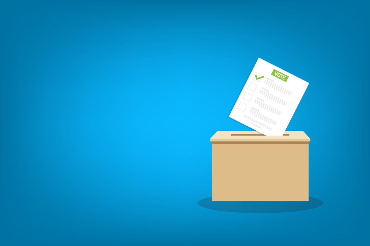 rendering of a wooden ballot box with a paper ballot above it