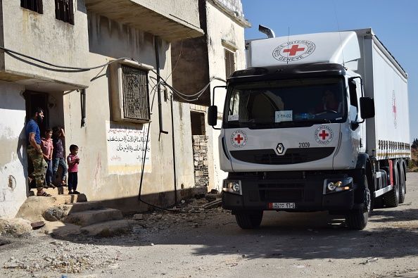 A Syrian family receives aid in Talbisseh.