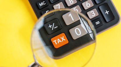 magnifying glass over tax calculator