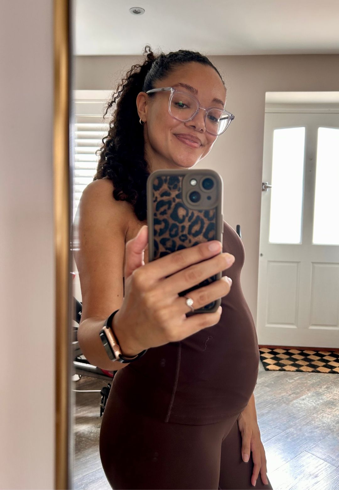 A mirror selfie of health writer Becks Shepherd trying Reformer Pilates while pregnant