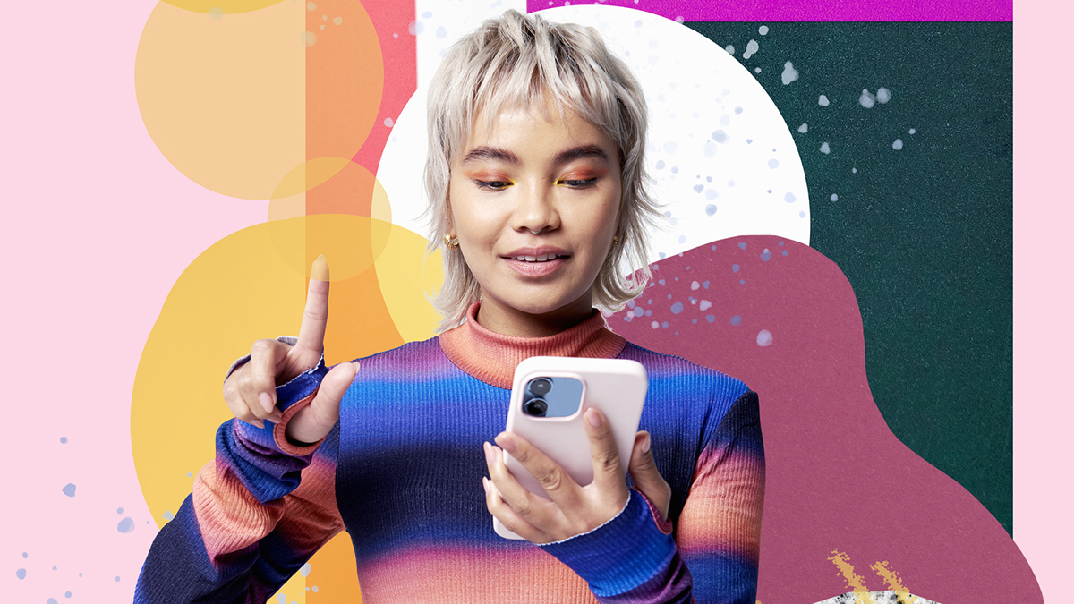 A woman uses a large mobile phone with a graphic background.