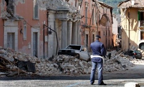 A policeman stands in front of collapsed buildings after an earthquake in Aquila, Italy, on April 7, 2009.