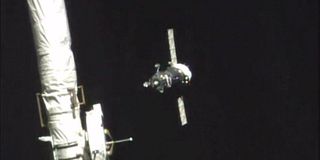 The Soyuz spacecraft carrying NASA astronaut Scott Kelly and Russian cosmonauts Mikhail Kornienko and Gennady Padalka is seen by a camera on the International Space Station during docking operations on March 27, 2015. Kelly and Kornienko are beginning a nearly 12-month mission in space.