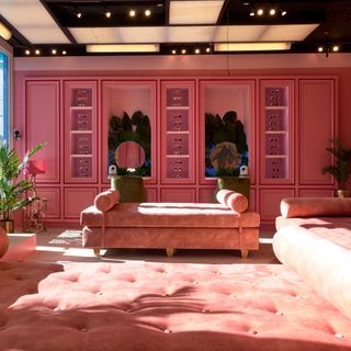 cbb 18 house pink dressing room with plush seating and mirror