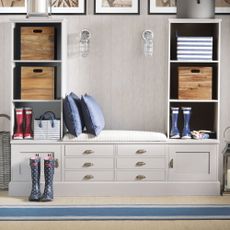 Hallway runner ideas a storage unit with a striped runner in front with wellies storage boxes and pictures on the wall