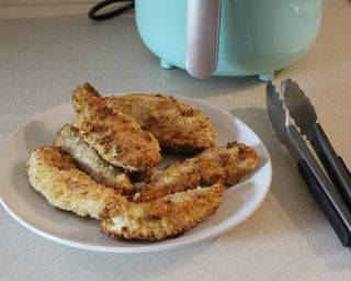 Breaded chicken tenders cooked in the Dash 2-quart air fryer