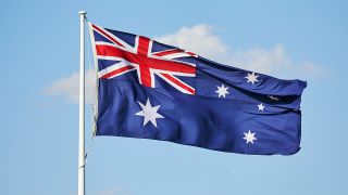 Australian flag flying in front of blue sky
