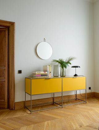 grey hallway with yellow cabinet by ligne roset