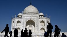 Visitors pass in front of the Taj Mahal in Agra, India.