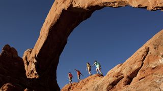 Family walking on rocks at Arches National Park