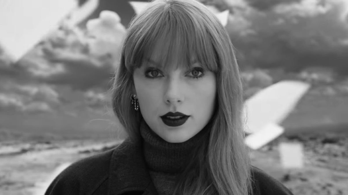 Black and white screenshot of Taylor Swift looking into camera in Fortnight video.