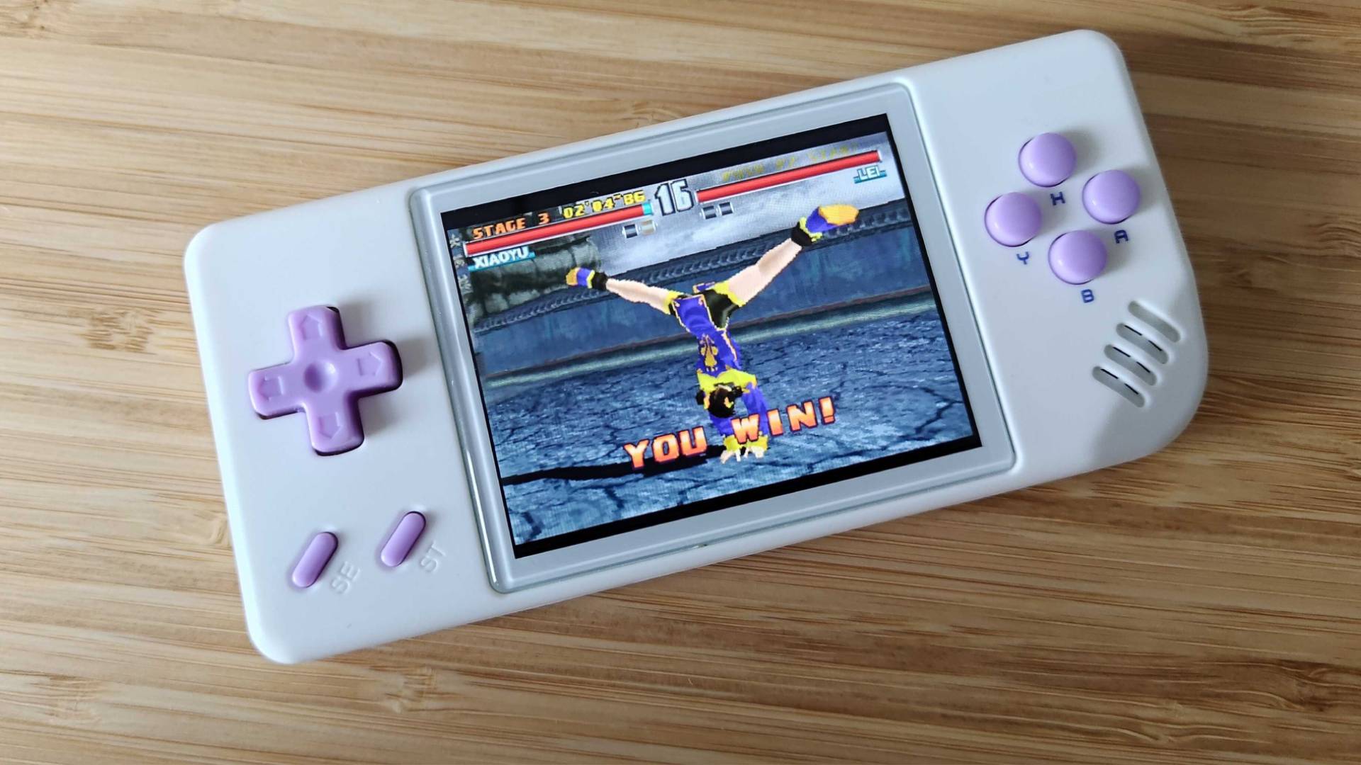 Anbernic RG28XX handheld with Tekken 3 gameplay on screen