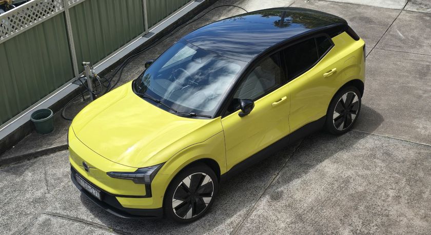 The Volvo EX30 electric car from the top down in an electric yellow color