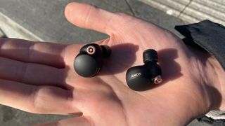 Sony WF-1000XM4 workout earbuds on a person's hand