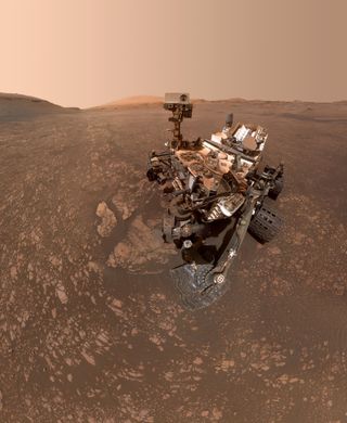 NASA's Curiosity rover, pictured here in a May 12 composite selfie, won't move as Earth and Mars reach opposite sides of the sun.