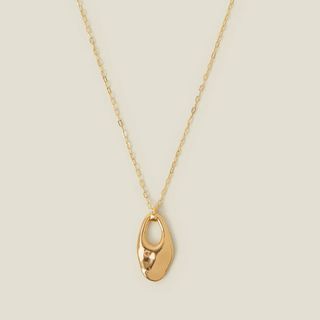 flat lay image of gold necklace