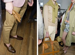 Guys wearing Dunhill S/S 2015 collection. The guy on the left is wearing short brown-green straight pants with red and white stripes with brown gloves in his hand. On the right, the left guy is wearing a cream pants with matching shirt and a jersey draped around his neck and the guy in the right is wearing a floral short with a long scarf and a long green jacket