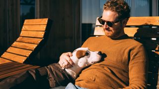 Man chilling with friendly dog