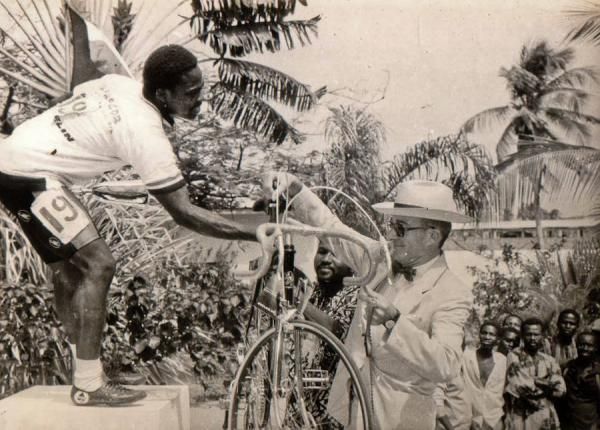 Saka receives a new bicycle after winning the 1987 Beninese Independence Day Road Race.