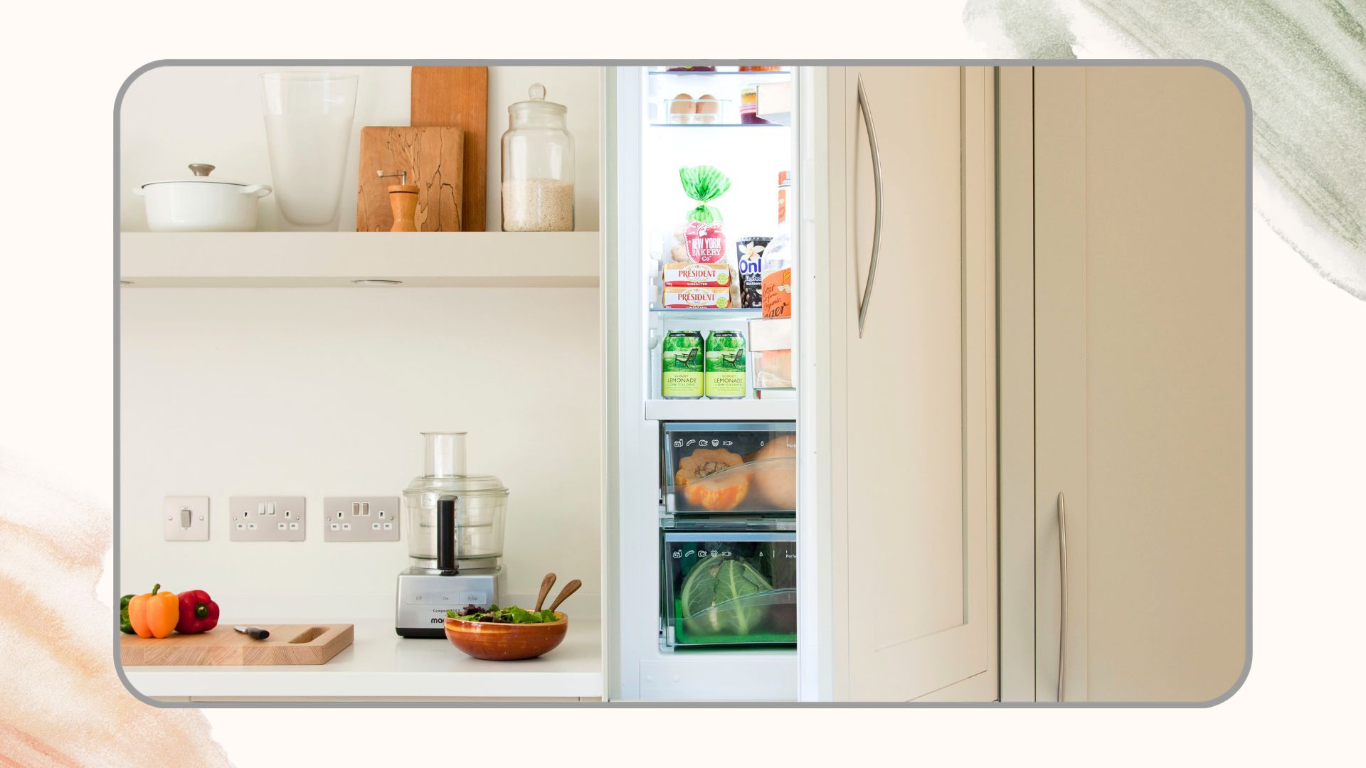 Cream kitchen with a built-in fridge with the door open to show IKEA fridge organisers instead