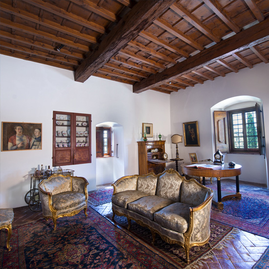 living room with wooden ceiling and sofa set with cushions