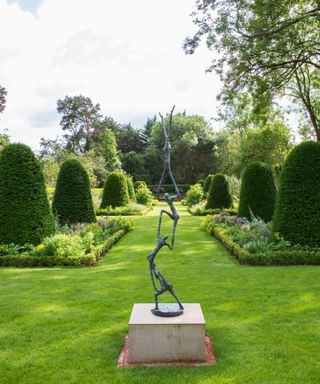 figurative garden sculpture in a formal garden area