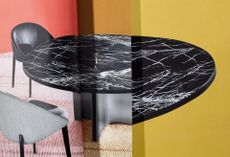 Collage of marble dining table by Rodolfo Dordoni for Minotti with black top featuring white veins