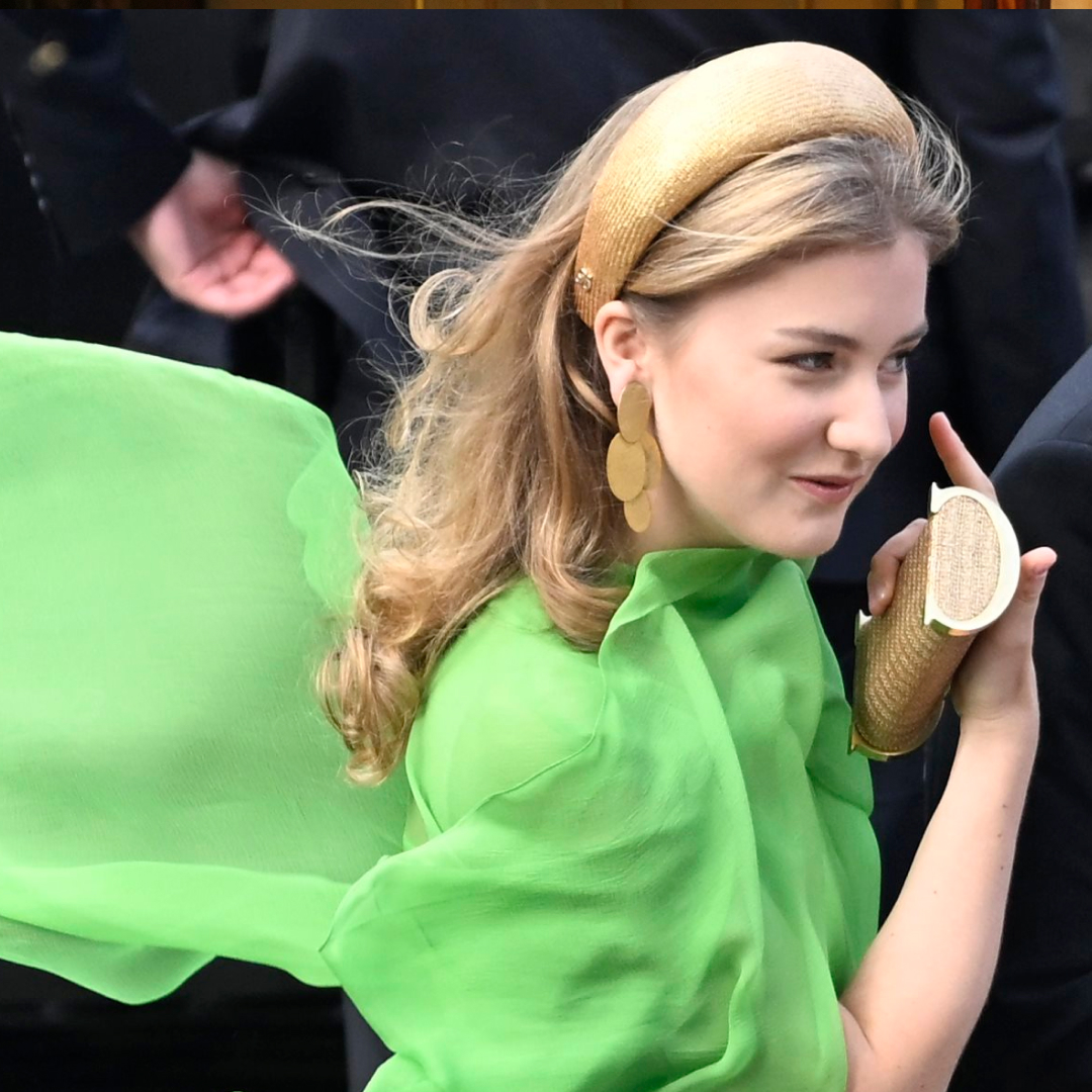 Princess Elisabeth of Belgium wearing a green caped dress flowing behind her
