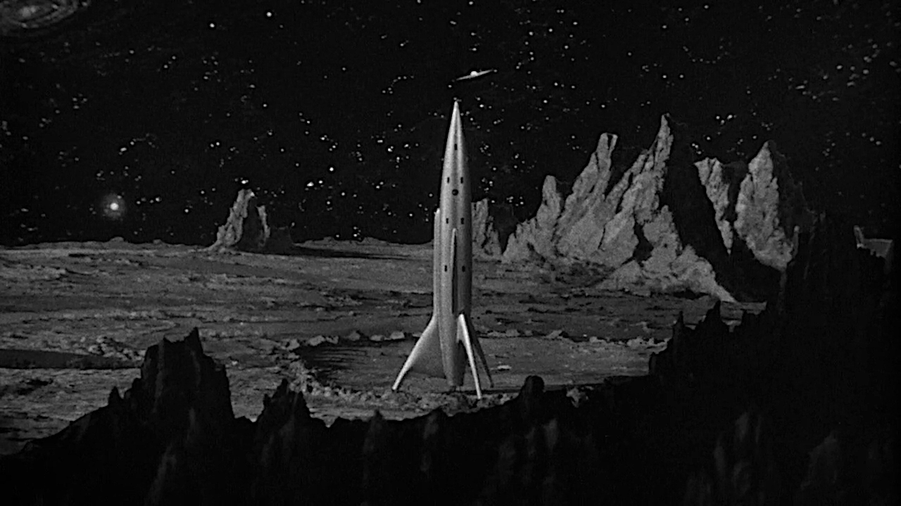 a silver spaceship on a barren planet