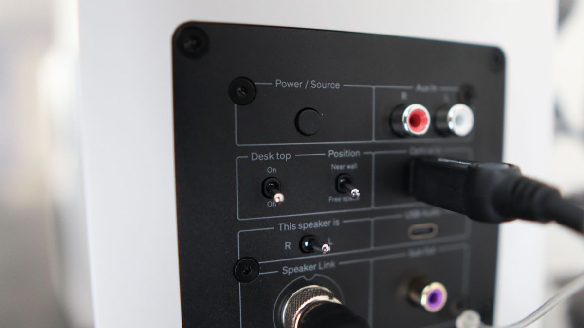 Cambridge Audio's L/R S speakers on a desk. The speakers are white with black tweeters.
