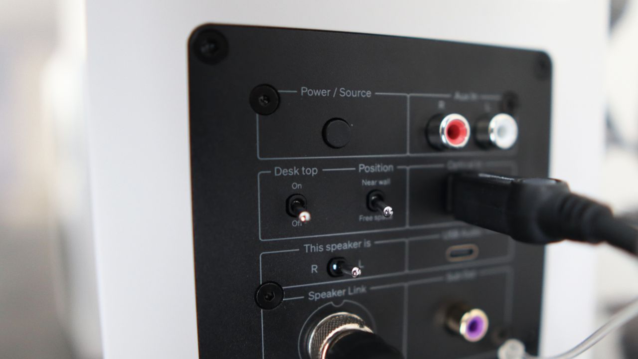 Cambridge Audio's L/R S speakers on a desk. The speakers are white with black tweeters.