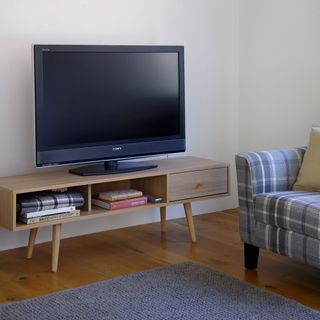 room with tv shelves and wooden flooring