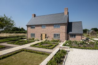 large front garden with sections in front of brick new build