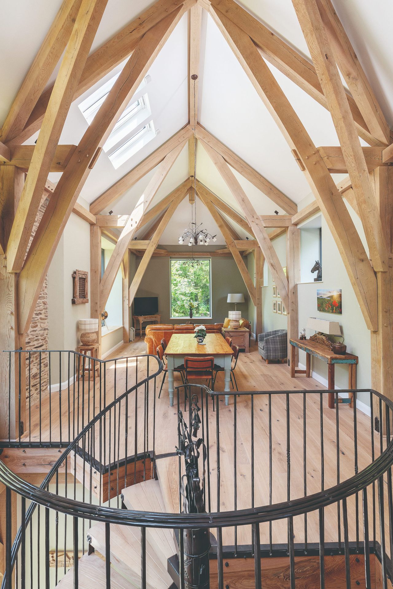 A modern barn conversion interior with vaulted ceilings, exposed beams and an open-plan living space