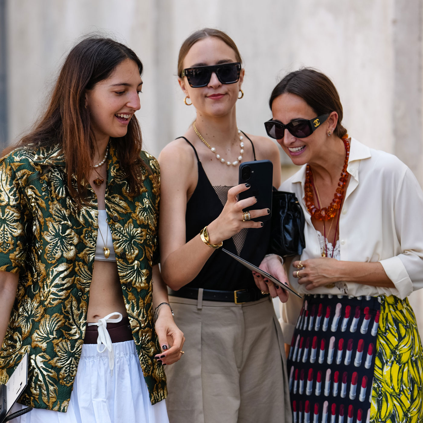 a group of women looking at a phone