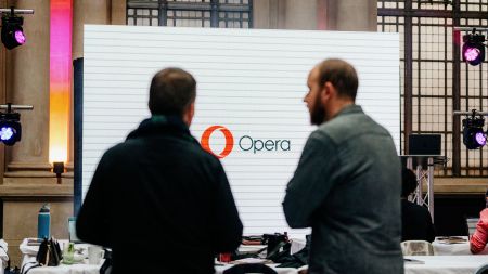 Two Opera Browser Days attendees standing in front of a screen displaying the Opera logo