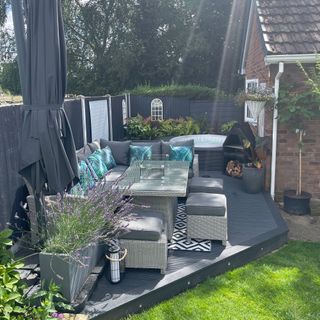 Outdoor dining area on raised decking with hot tub