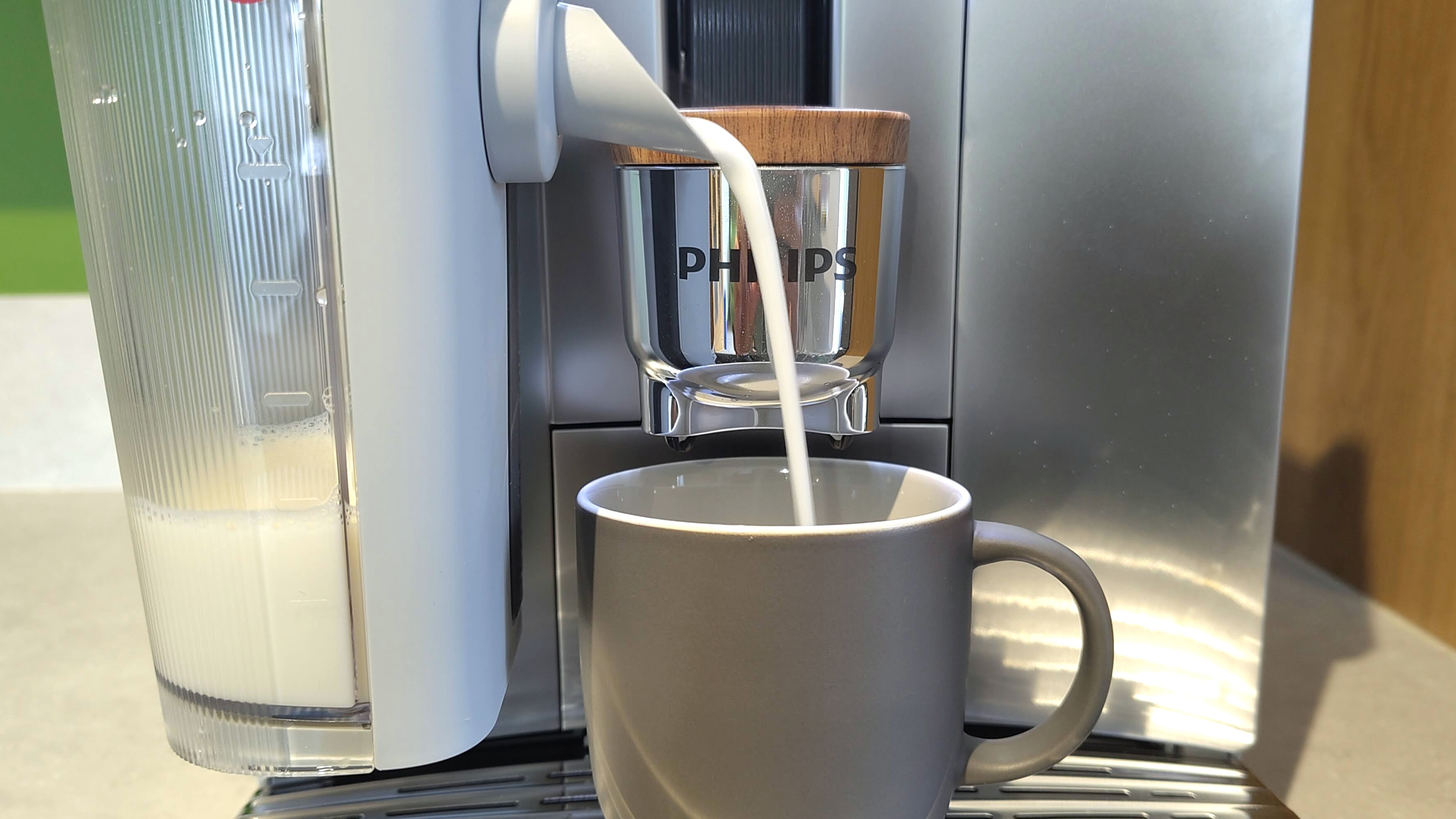 Philips Caf&amp;eacute; Aromis coffee maker dispensing steamed oat milk
