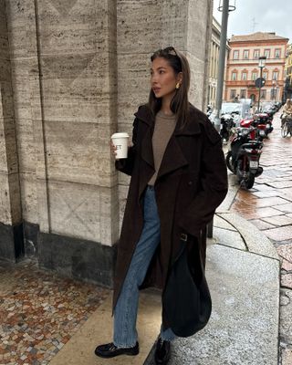 An image of influencer @fakerstrom wearing a cashmere coat while out in Milan.