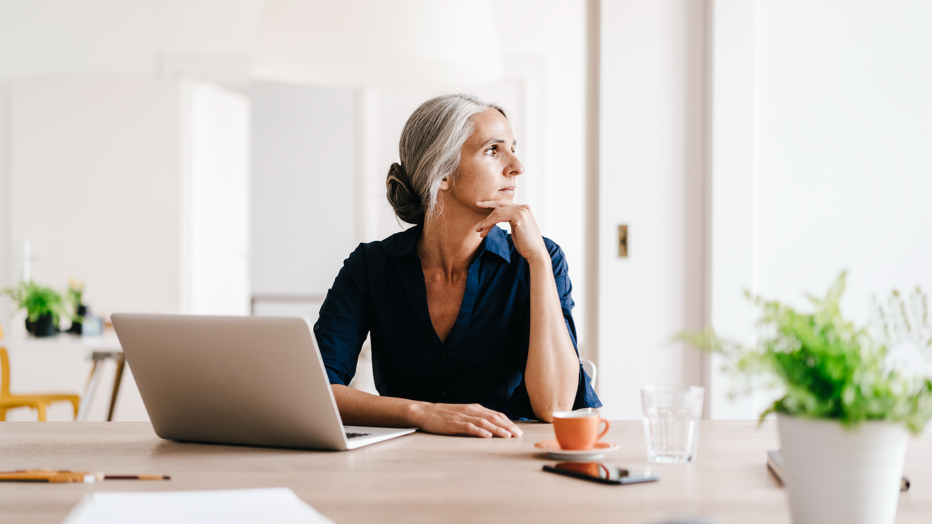 Woman sat working on laptop at table