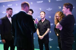 Prince William speaks with the band OneRepublic backstage at the Earthshot Prize Awards