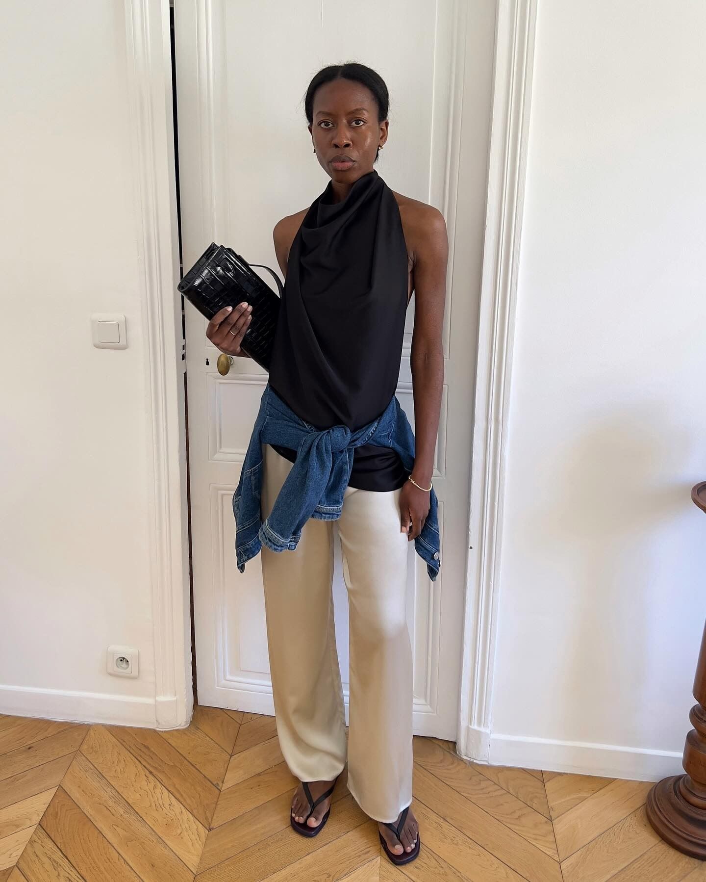 Influencer wearing spring 2026 outfit with silk and satin pants.