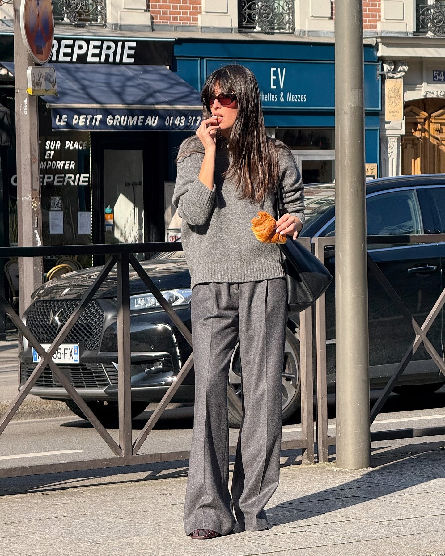 @tamaramory wearing a gray cashmere sweater and wool trousers.