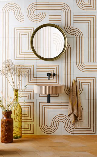 retro pattern wall tiled bathroom, small wall mounted basin, terracotta floor tiles, two vases