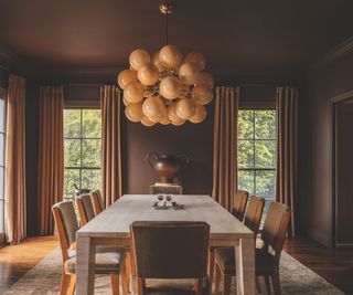 dining area with large rectangular dining table and cluster pendant light