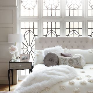white bedroom with bed and windows